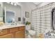Cozy bathroom with a neutral color scheme and a decorative shower curtain at 167 Wandering Wetlands Cir, Bradenton, FL 34212