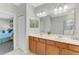 Bright bathroom with double vanity and access to bedroom at 167 Wandering Wetlands Cir, Bradenton, FL 34212