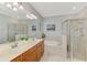 Spacious bathroom featuring double sinks, a glass shower, and a soaking tub at 167 Wandering Wetlands Cir, Bradenton, FL 34212