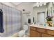 Cozy bathroom with a shower and tub, a vanity with under-cabinet storage and a mirror at 167 Wandering Wetlands Cir, Bradenton, FL 34212