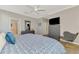 Comfortable bedroom featuring wood floors, a ceiling fan, and a gray dresser with a TV at 167 Wandering Wetlands Cir, Bradenton, FL 34212