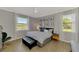 Bright bedroom with cool-toned walls and views from two large windows at 167 Wandering Wetlands Cir, Bradenton, FL 34212