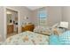 Twin beds in bright bedroom featuring coastal decor and natural light at 167 Wandering Wetlands Cir, Bradenton, FL 34212