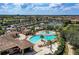 Aerial view of the community pool, with ample seating and lush greenery, perfect for relaxation at 167 Wandering Wetlands Cir, Bradenton, FL 34212