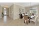 Formal dining room with elegant lighting, neutral walls, and a view of the front entry at 167 Wandering Wetlands Cir, Bradenton, FL 34212