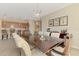 Open concept dining room with wet bar, modern light fixture, with kitchen in background at 167 Wandering Wetlands Cir, Bradenton, FL 34212