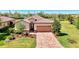 Charming single-Gathering home boasting a brick paved drive, manicured lawn and lush landscaping for enhanced curb appeal at 167 Wandering Wetlands Cir, Bradenton, FL 34212