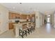 Spacious kitchen featuring stainless appliances, a center island with seating, and ample cabinet space at 167 Wandering Wetlands Cir, Bradenton, FL 34212