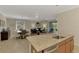 Kitchen island with granite countertop, stainless steel dishwasher overlooking breakfast nook and living room at 167 Wandering Wetlands Cir, Bradenton, FL 34212