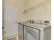Functional laundry room features stainless steel washer and dryer and overhead shelving at 167 Wandering Wetlands Cir, Bradenton, FL 34212
