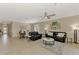 Open-concept living room with dining area and dark leather sofas at 167 Wandering Wetlands Cir, Bradenton, FL 34212