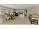 Open-concept living space with tile flooring, dining area, and sliding glass doors to the patio at 167 Wandering Wetlands Cir, Bradenton, FL 34212