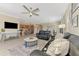 Living room featuring dark leather sofas and open to kitchen and dining areas at 167 Wandering Wetlands Cir, Bradenton, FL 34212