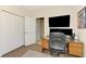 The well-lit office area includes a desk, monitors, closet and wood-look flooring at 167 Wandering Wetlands Cir, Bradenton, FL 34212