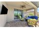 Relaxing outdoor space with a plush seating area, a ceiling fan, and a mounted TV at 167 Wandering Wetlands Cir, Bradenton, FL 34212