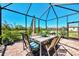 Inviting screened-in lanai with dining table and seating, offering a relaxing outdoor space at 167 Wandering Wetlands Cir, Bradenton, FL 34212