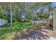 Spacious backyard with lush greenery, fencing, and an outdoor shower, perfect for relaxation and privacy at 1679 Arlington St, Sarasota, FL 34239