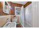 Cozy bathroom featuring a tub-shower combo, bamboo accents and a pedestal sink at 1679 Arlington St, Sarasota, FL 34239