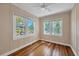 Cozy bedroom with hardwood floors and plenty of natural light from three large windows at 1679 Arlington St, Sarasota, FL 34239