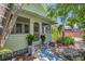 Inviting front porch with tiled walkway and well-maintained landscaping in this charming home at 1679 Arlington St, Sarasota, FL 34239