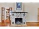 Cozy living room featuring a unique stone fireplace and classic hardwood floors at 1679 Arlington St, Sarasota, FL 34239