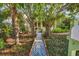 Inviting home exterior with mature trees and a tiled mosaic walkway at 1679 Arlington St, Sarasota, FL 34239