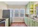 Bright kitchen featuring a stainless steel refrigerator, colorful backsplash, and ample natural light at 1679 Arlington St, Sarasota, FL 34239