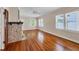Spacious living room with hardwood floors, a fireplace, and natural light from large windows at 1679 Arlington St, Sarasota, FL 34239