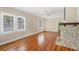 Bright living room featuring hardwood floors and a unique shell fireplace at 1679 Arlington St, Sarasota, FL 34239