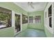 Enclosed front porch with windows and unique lattice details, perfect for relaxing at 1679 Arlington St, Sarasota, FL 34239