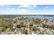 Beautiful aerial view of a home in a suburban neighborhood near a bay with a blue sky with clouds at 1827 Nevada Ne Ave, St Petersburg, FL 33703