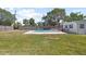 Backyard features an in-ground pool, grass and a privacy fence at 1827 Nevada Ne Ave, St Petersburg, FL 33703
