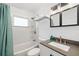Bright bathroom with tub and shower combo, white subway tile and modern vanity with sink at 1827 Nevada Ne Ave, St Petersburg, FL 33703