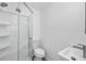 Bathroom featuring a glass-enclosed shower, toilet, and modern sink with stylish faucet at 1827 Nevada Ne Ave, St Petersburg, FL 33703