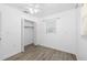 Bedroom featuring a closet with open doors, a window, wood floors, and neutral walls at 1827 Nevada Ne Ave, St Petersburg, FL 33703