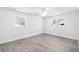 A bright bedroom featuring wood-style flooring, a ceiling fan, and two windows, offering a serene space at 1827 Nevada Ne Ave, St Petersburg, FL 33703