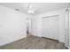 Bright bedroom featuring wood-style flooring, a ceiling fan, a closet and ensuite access at 1827 Nevada Ne Ave, St Petersburg, FL 33703