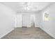 A bright bedroom with a ceiling fan, wood-style flooring, closet and an ensuite bathroom at 1827 Nevada Ne Ave, St Petersburg, FL 33703