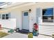 Charming home's front door with light blue paint, decorative plants, and stylish accents at 1827 Nevada Ne Ave, St Petersburg, FL 33703