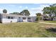 Charming single-story home with a carport and a well-manicured lawn on a sunny day at 1827 Nevada Ne Ave, St Petersburg, FL 33703
