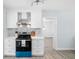 Modern kitchen showcasing white cabinets, stainless steel appliances, and sleek countertops at 1827 Nevada Ne Ave, St Petersburg, FL 33703