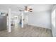 Spacious living room featuring tiled floors, modern lighting, and an open layout to the kitchen at 1827 Nevada Ne Ave, St Petersburg, FL 33703