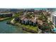 Aerial view of waterfront condos with lush landscaping, showcasing community amenities and water access at 1900 Cove Ii Pl # 133, Sarasota, FL 34242