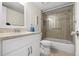 Well-lit bathroom with sleek vanity, tiled floors, and shower-tub combo at 1900 Cove Ii Pl # 133, Sarasota, FL 34242