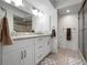 Modern bathroom boasts double sinks, granite countertops, and tiled walk-in shower at 1900 Cove Ii Pl # 133, Sarasota, FL 34242