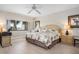 Serene bedroom with a king-size bed, tropical decor, and bright natural lighting at 1900 Cove Ii Pl # 133, Sarasota, FL 34242
