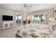 Bright bedroom with light wood floors features lanai access and a gorgeous waterfront view at 1900 Cove Ii Pl # 133, Sarasota, FL 34242