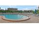 Community pool featuring plenty of seating and a nearby view of the building at 1900 Cove Ii Pl # 133, Sarasota, FL 34242