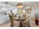 Bright dining area with a glass table, stylish chairs, and adjacent modern kitchen, great for entertaining at 1900 Cove Ii Pl # 133, Sarasota, FL 34242