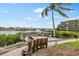 Scenic waterfront dock with benches, offering beautiful views of the bridge and surrounding landscape at 1900 Cove Ii Pl # 133, Sarasota, FL 34242